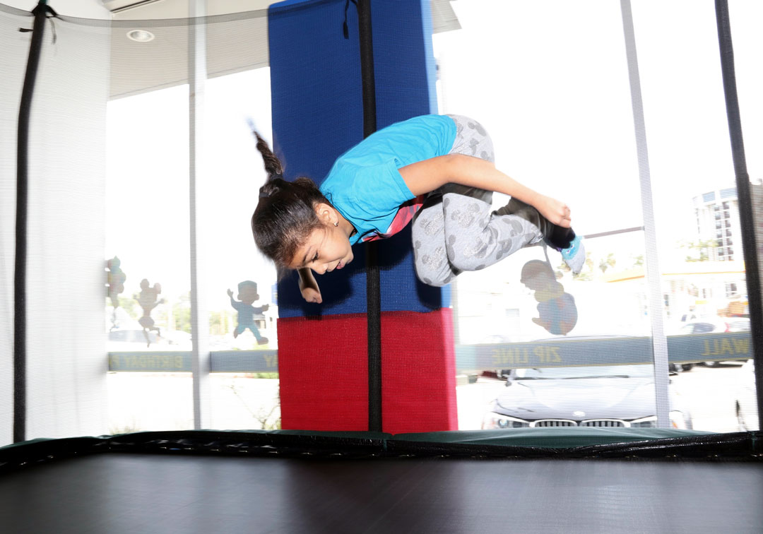 girl doing flips on trampoline