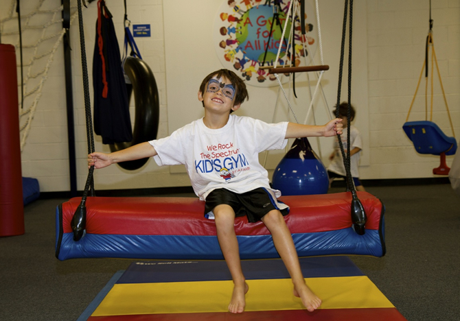 kid on bolster swing