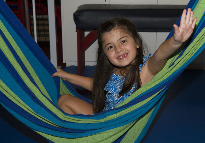 girl smiling in hammock swing